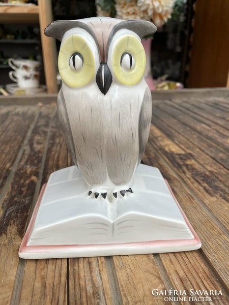 Porcelain owl sitting on a large book