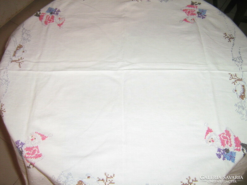 Beautiful cross-stitch hand-embroidered white winter tablecloth with Santa Claus