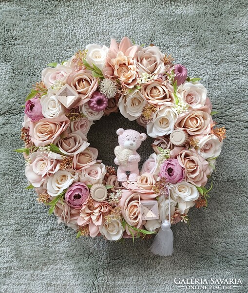 Wreath full of flowers with a teddy bear heart