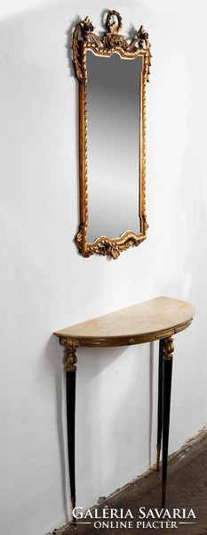 A gilded carved mirror wrapped around with a ribbon pattern