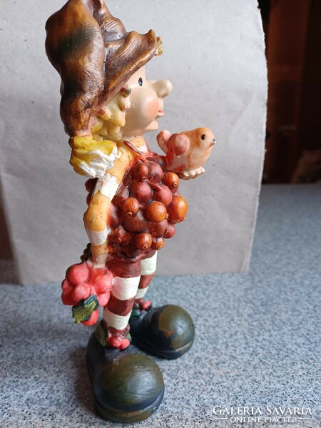 Polyresin figure, boy with bird.