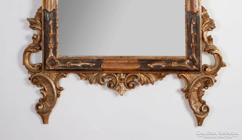 Carved wooden framed mirror with top decoration