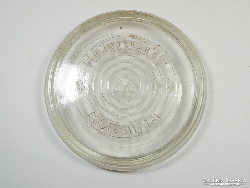 Antique old canning glass lid with hermetic moravia inscription