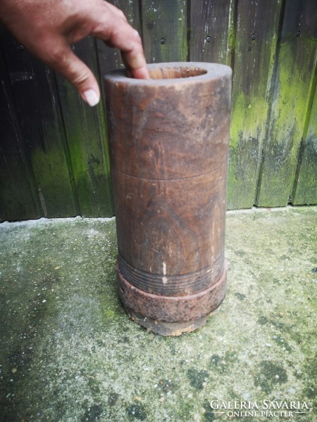 Antique wooden mortar with wrought iron hammer 1800s folk museum-type object. Crop seeds