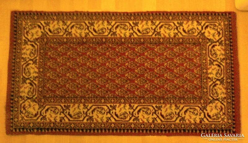 Small carpet with a red pattern