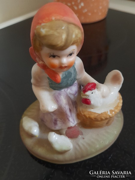 Ceramic little girl figurine with hen and chicks
