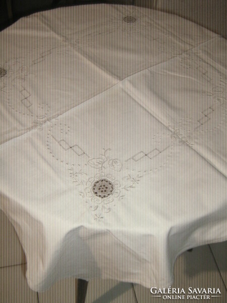 Beautiful hand-crocheted beige tablecloth with floral pattern