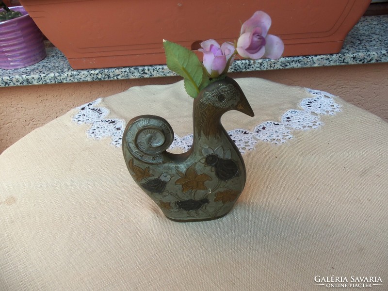 Ornament of a bird holding a flower
