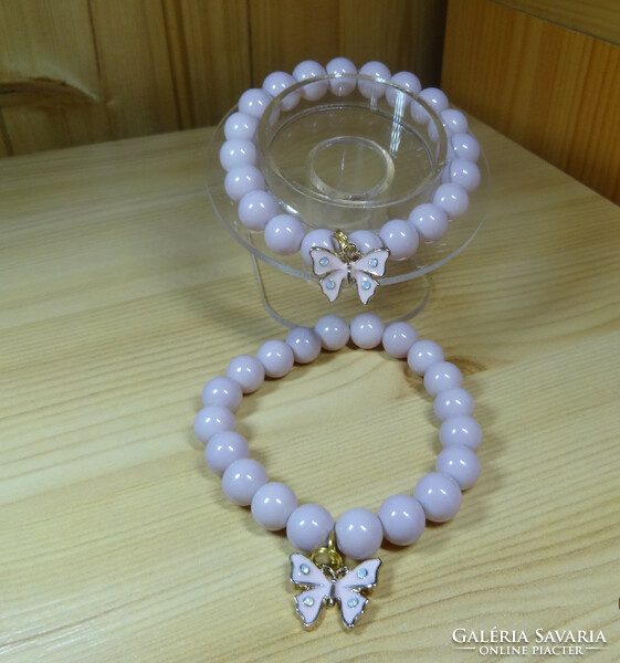 A bracelet made of beautiful, shiny powder-colored glass beads with fire enamel butterfly decoration