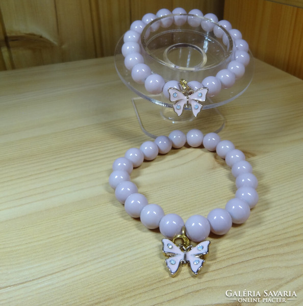 A bracelet made of beautiful, shiny powder-colored glass beads with fire enamel butterfly decoration