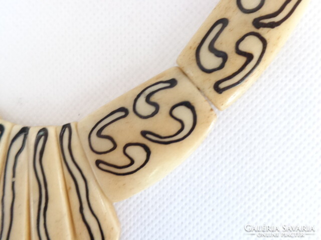 Old bone necklace with signs and pattern