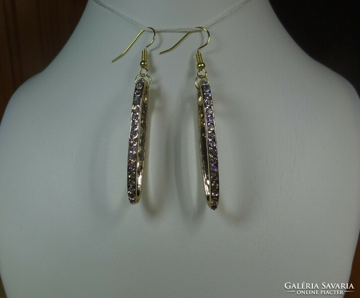 Oval gold-colored earrings with crystal stones