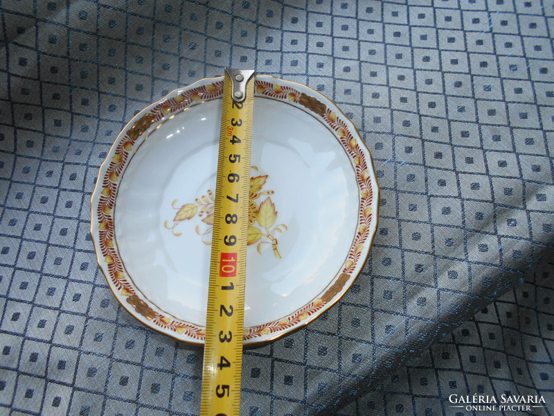 A plate with an Appony pattern - served from its rare orange size on the bottom of a tea cup