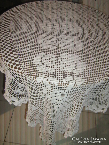 Beautiful special white hand-crocheted boat-shaped lace tablecloth with a flower pattern