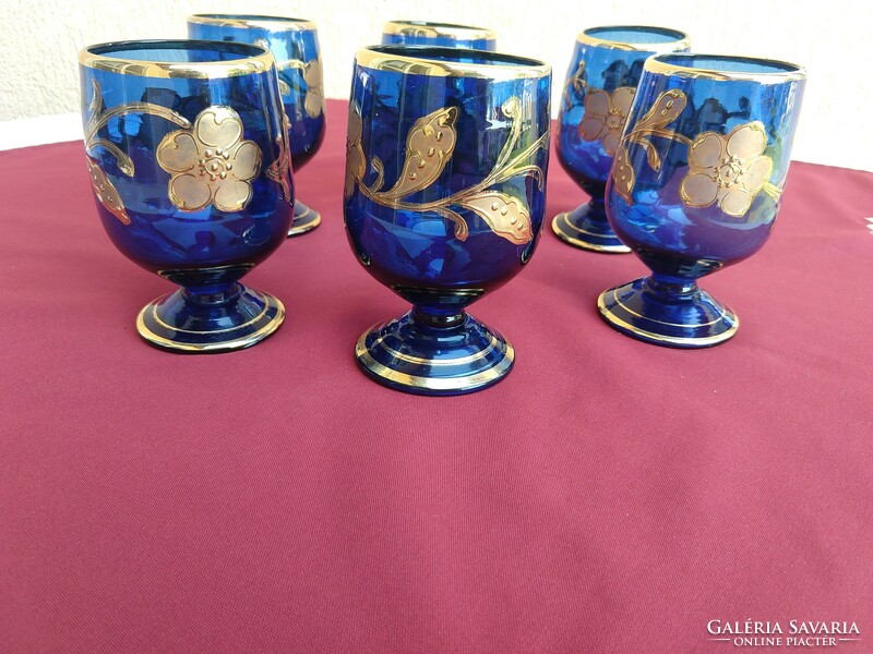 A set of six blue, richly gilded, stemmed glasses with a broken bottom, 12 cm high,,