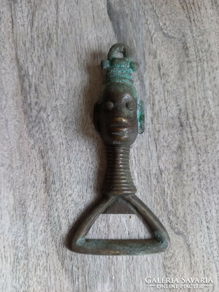 Interesting old copper beer opener with a portrait of an African woman (11x5.2 cm)
