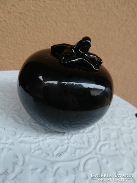 Black tomato in glass leaf weight