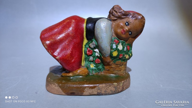 Marked antique ceramic figure of a girl with a bouquet