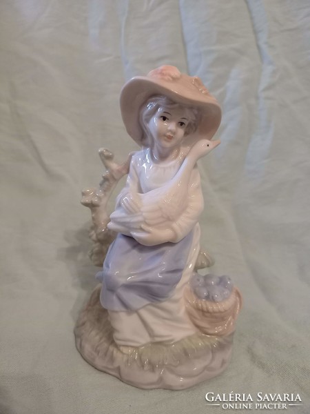 Larger female porcelain figurine with goose and basket 16 cm