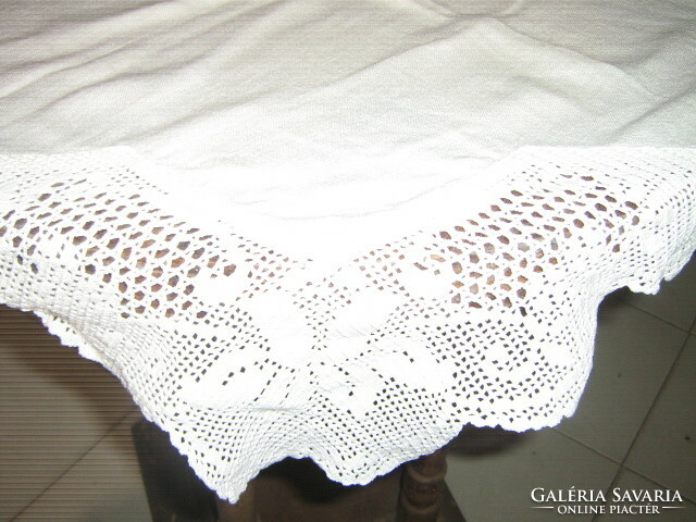 A beautiful star-shaped tablecloth with a crocheted edge with a floral pattern