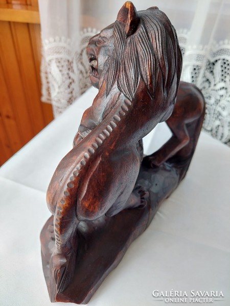 A wooden carved two roaring lions in very good condition.