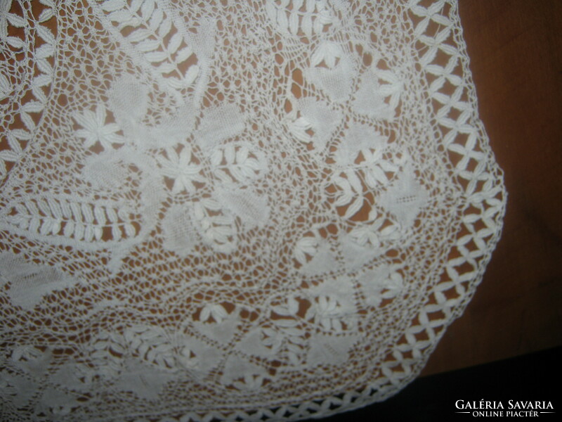 Old lace tablecloth with a cross