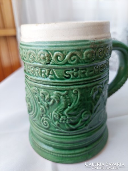 Green cup with an inscription