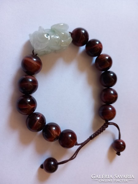 A beautiful bracelet decorated with a large tiger's eye and a carved jade dragon
