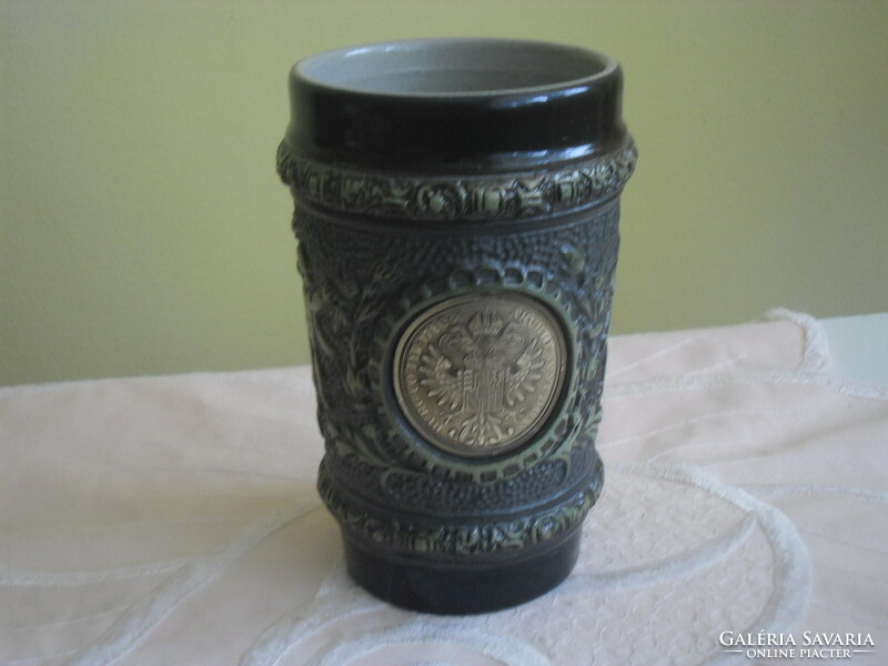 Decorative majolica cup decorated with an old coin
