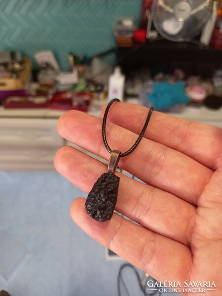 Raw tektite meteorite pieces on a leather chain