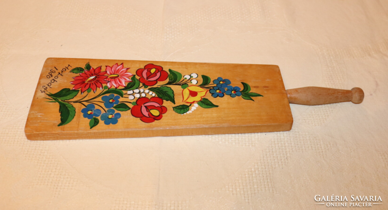 Wooden wall decoration with painted folk motifs