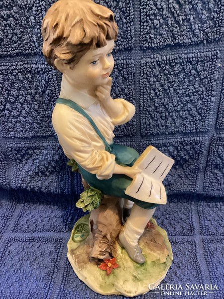 Capodimonte statue of a boy reading a book