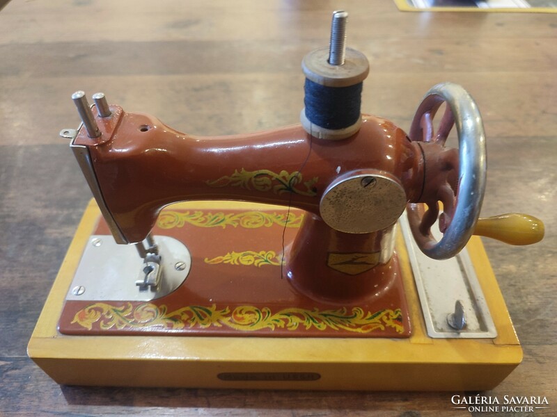 Toy sewing machine. Functional, genuine, antique, retro, vintage item.