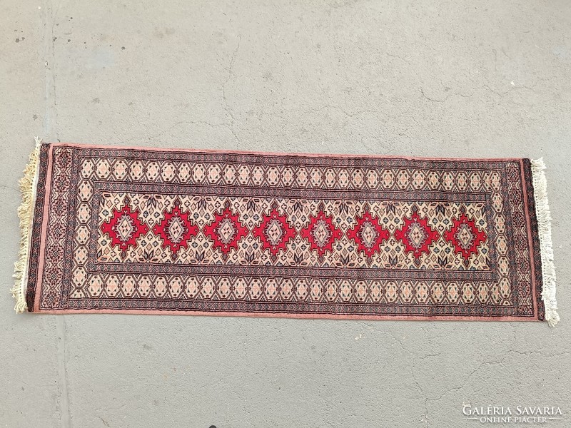 Old machine-knotted carpet used as a wall protector 509 7722