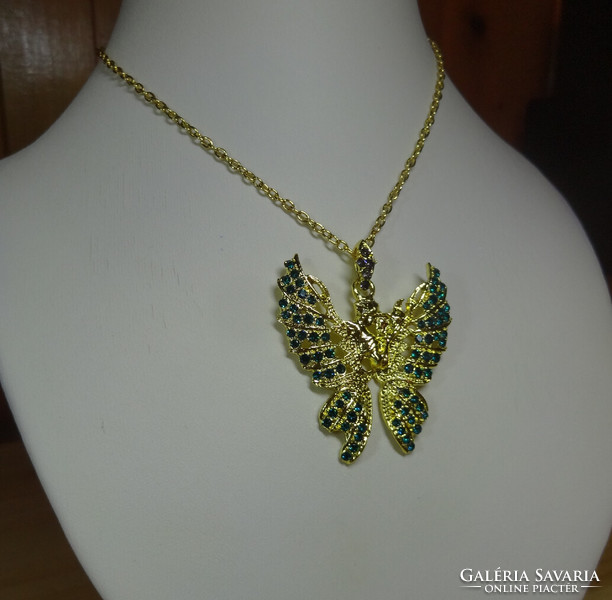 A beautiful butterfly pendant necklace with a dream inducing gentle feelings, with a couple in love in the middle.