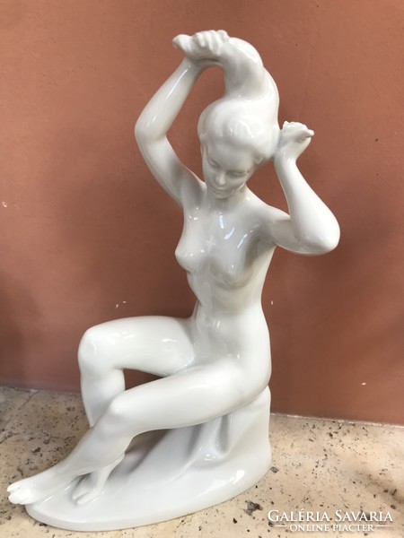 Porcelain lady combing her hair, in good condition