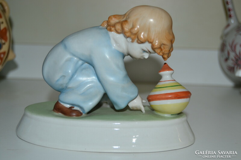 A child playing with a porcelain snail from Zsolnay