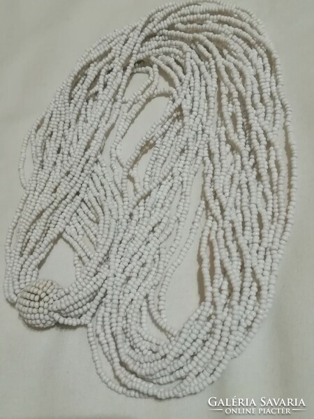 Retro or antique necklace with multiple white glass beads.