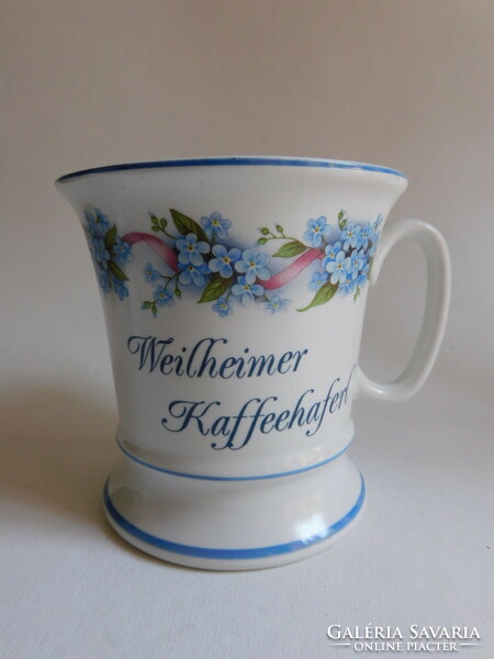 Old mug with forget-me-not pattern