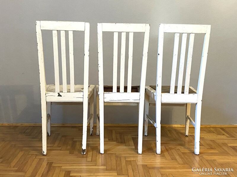 3 white high-back elegant dining chairs