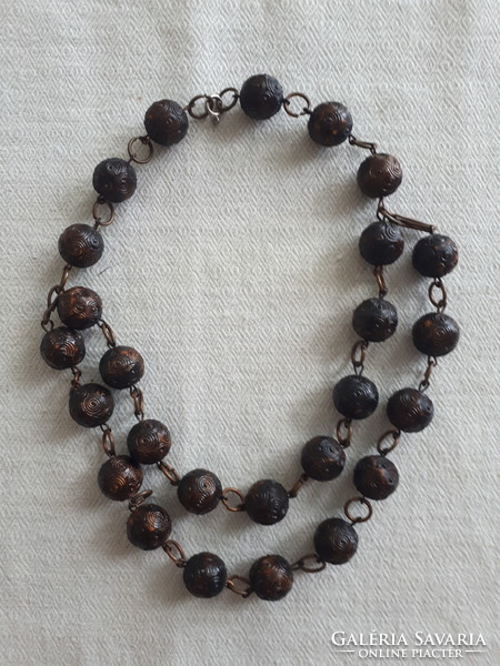 Two-row wooden necklace with burnt decoration