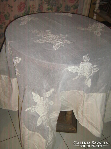 A special tablecloth with a dreamy organza insert, sewn with a rose pattern