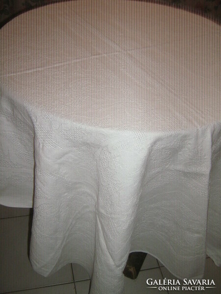 White woven tablecloth with a baroque leaf pattern in its beautiful material
