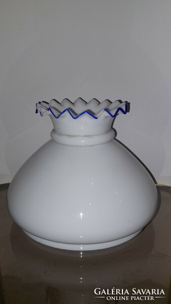 A milk glass bottle with a frilled top