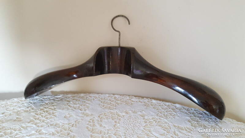 Old, curved, thick wooden hanger