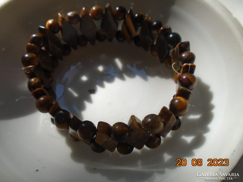 A bracelet made of polished faceted flat rhombus and spherical tiger eye pearls with high quality work