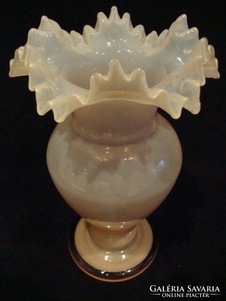 A dreamy glass vase with a frilled top, flawless