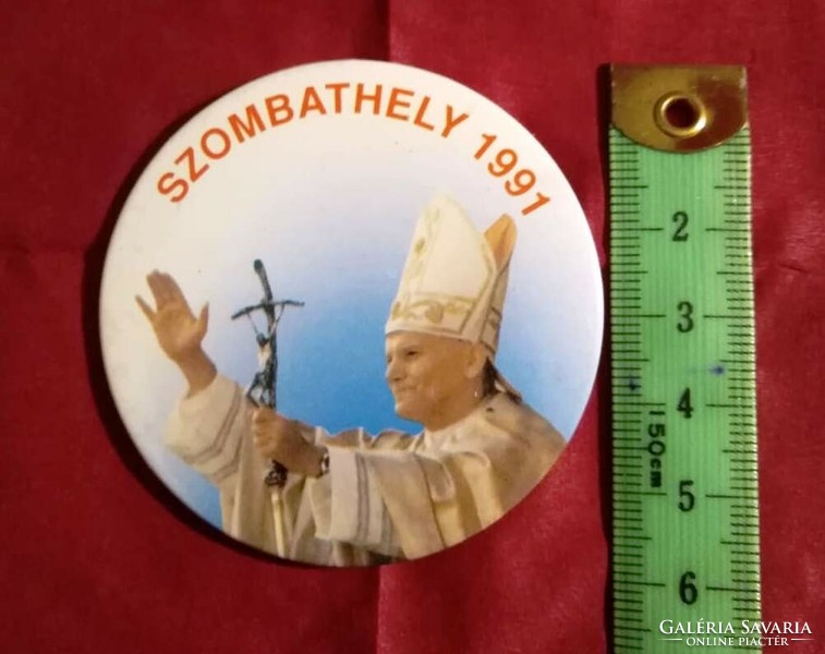 A badge issued to commemorate a papal visit is for sale in 1991.