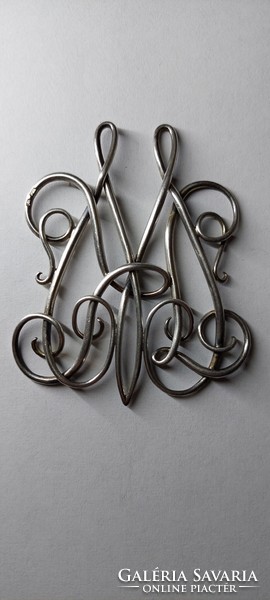 Old silver, either a pendant or a monogram, in any case a beautiful piece, marked