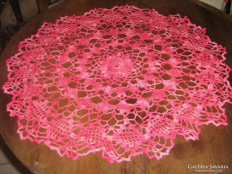 Beautiful hand-crocheted round lace tablecloth made of transition-colored yarn